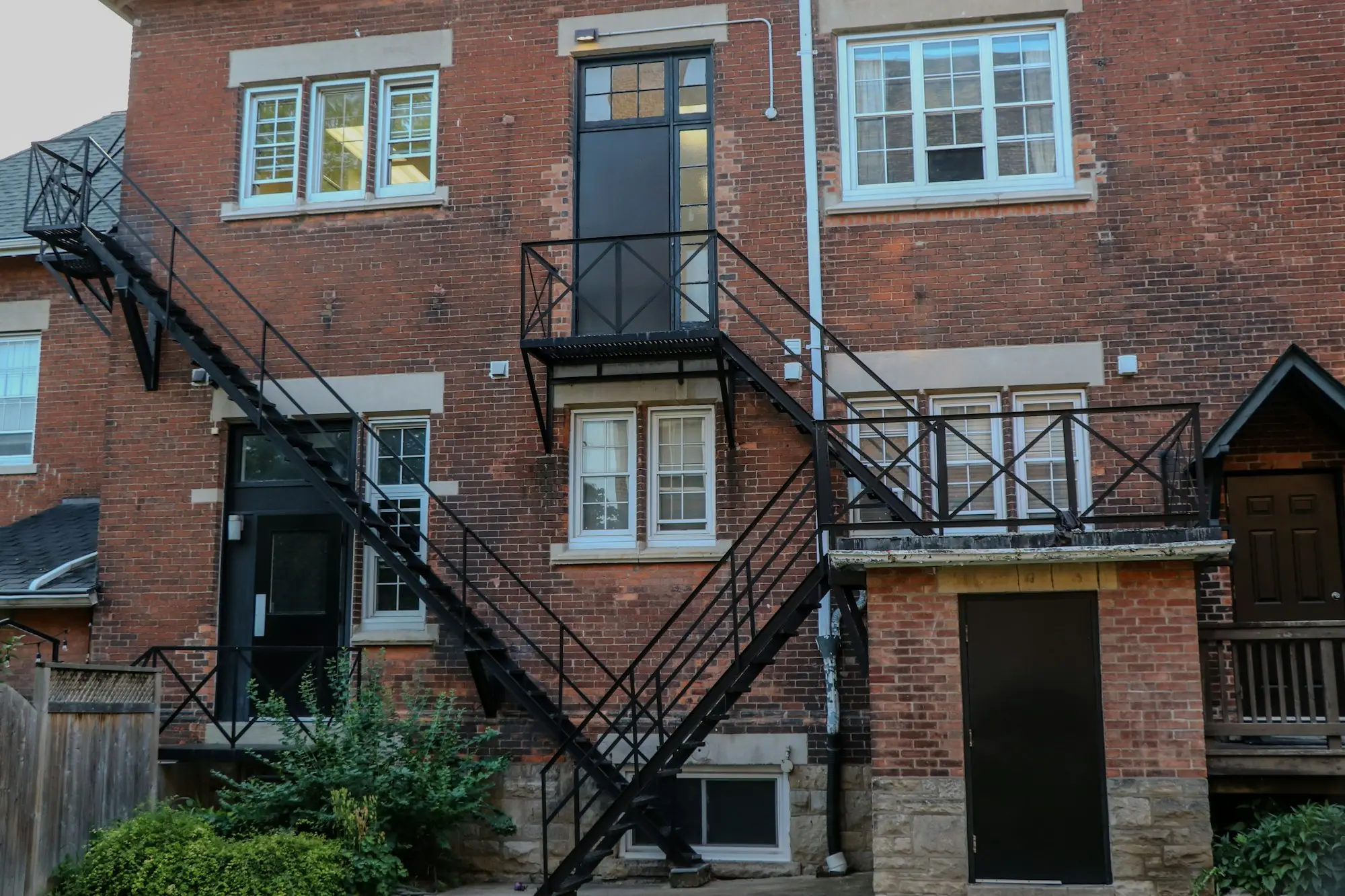 Old brick commercial building with a black metal fire escape