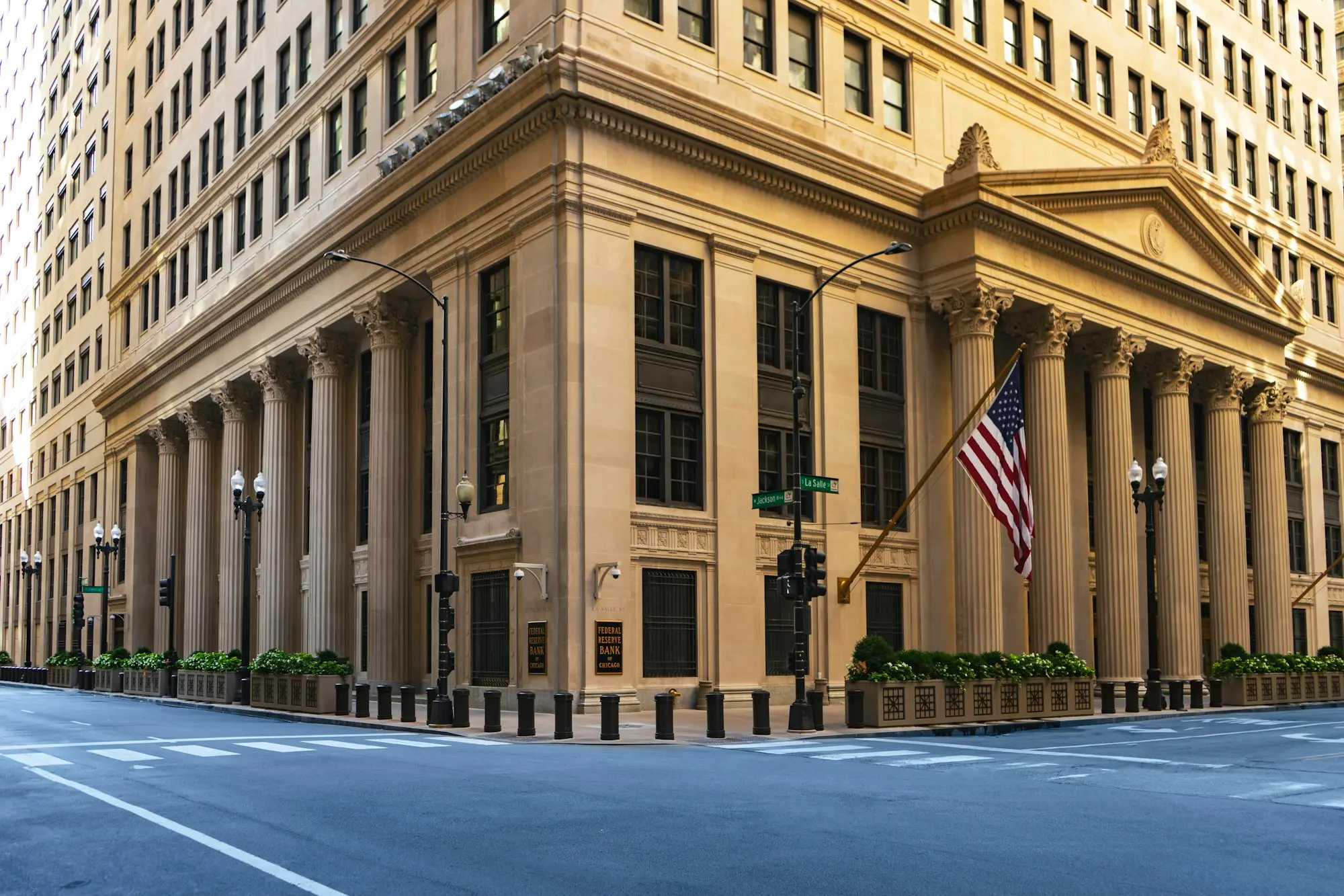 Heritage building with columns and a flag on the corner
