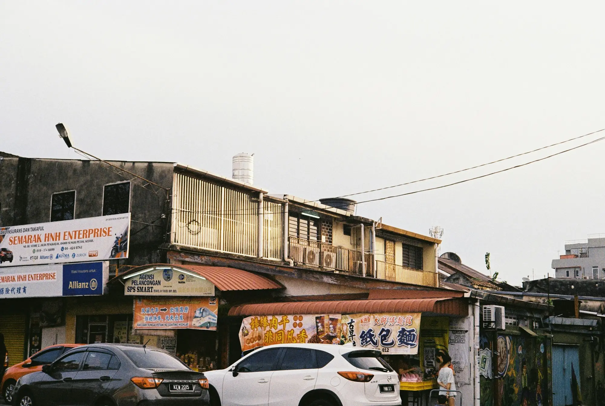 Cars passing old shopfront buildings on a main street